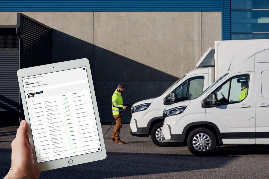 A person standing next to a row of white vans

AI-generated content may be incorrect.